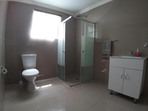 a bathroom with a toilet and a shower and a sink at Vaal Marina Resort in Vaal Marina