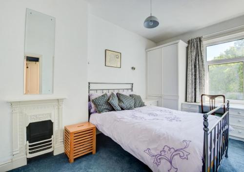 a bedroom with a bed and a fireplace at Green Gable in Skipton