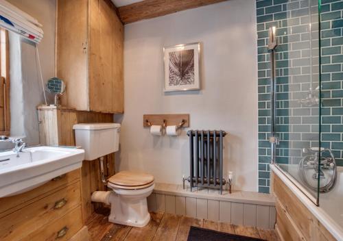 a bathroom with a toilet and a sink and a shower at Green Cottage in Robin Hood's Bay