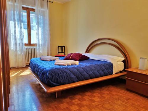 a bedroom with a large bed with a wooden frame at Giardino sul Naviglio in Milan