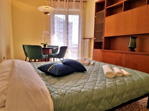 a bedroom with a bed with pillows and a table at Giardino sul Naviglio in Milan