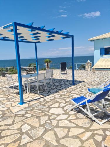 a group of chairs and tables on the beach at Iris Villas in Spárton