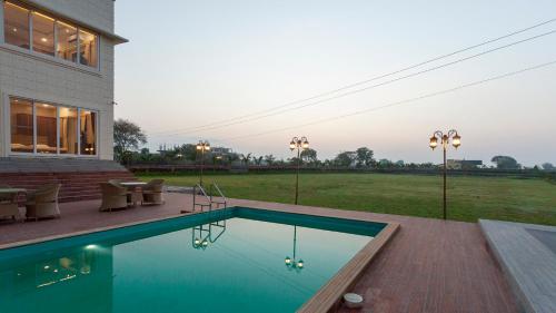 a swimming pool in the backyard of a house at The Arowana Divine in Nānded