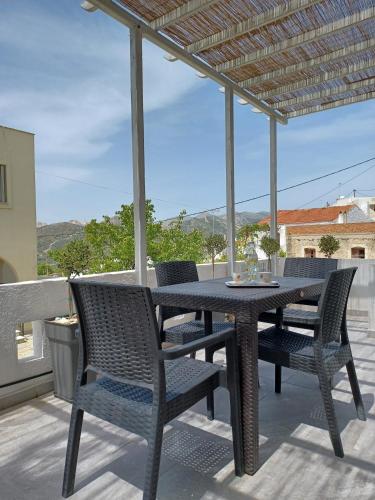 a black table and chairs on a patio at Traditional house in the heart of Naxos in Dhamariónas