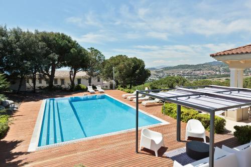 a villa with a swimming pool on a wooden deck at Luxury Seaview Villa by Olala Homes in Teià