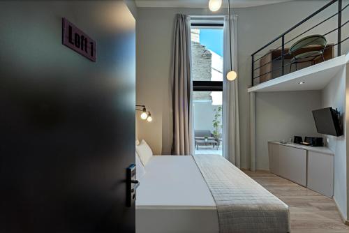 a bedroom with a king sized bed and a balcony at BED in Athens in Athens
