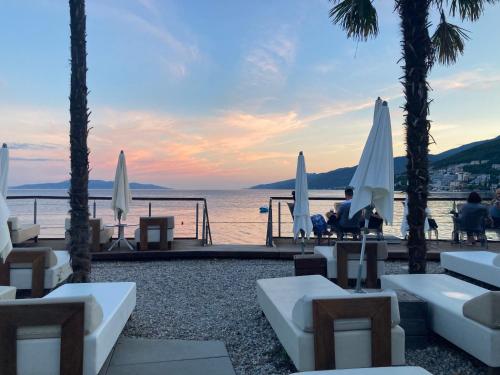 a view of the ocean from a resort with umbrellas at Villa Marija in Opatija