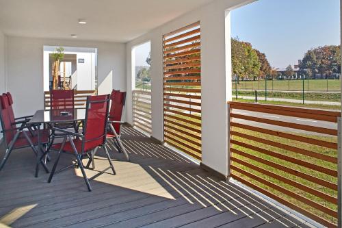 a screened porch with a table and chairs on it at Mobile Homes Terme Jezercica in Donja Stubica