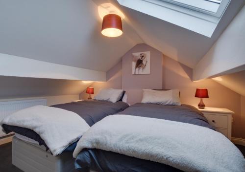 two beds in a room with a attic at Fellside in Kettlewell