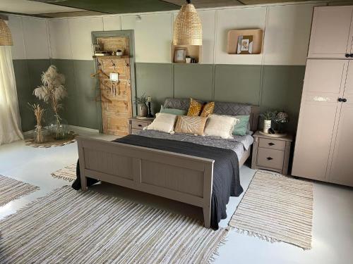 a bedroom with a bed with pillows on it at Wiire old fishermans farmhouse and smoke sauna in Saulepa