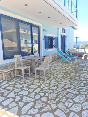 a patio with a table and chairs on a house at Iris Villas in Spárton