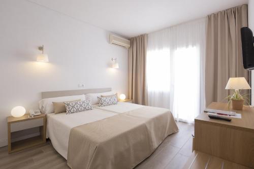 a hotel room with a large bed and a television at Cabot Romantic- Adults Only in Port de Pollensa