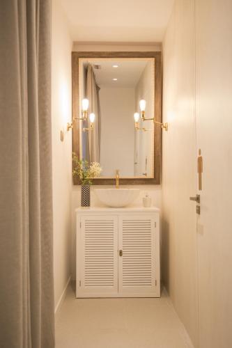 a bathroom with a white sink and a mirror at Cabot Romantic- Adults Only in Port de Pollensa