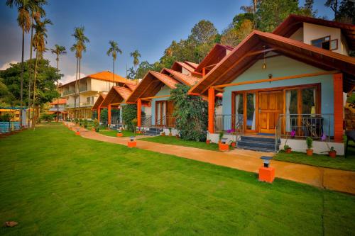 a row of houses with a green lawn at Hill Crest Resort - Coorg in Madikeri
