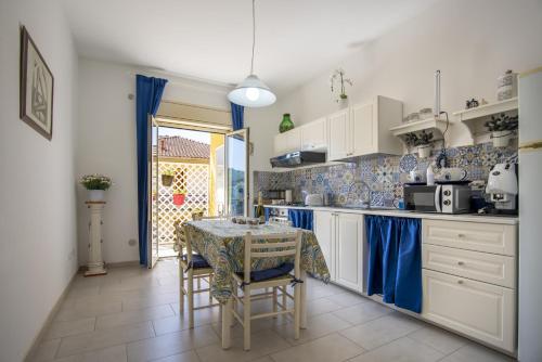 a kitchen with a table and chairs in a kitchen at Etna Sicilian House in Linguaglossa