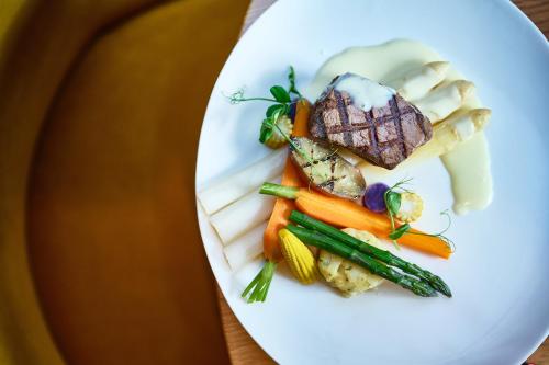 a plate of food with meat and vegetables on it at Hotel 't Kruisselt in De Lutte
