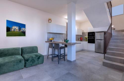 a kitchen and living room with a couch and a table at Casa B, Room 5 - mit Pool - at Lagoon - Lo Stagnone Kite Spot - Palm Kite Paradise in Marsala