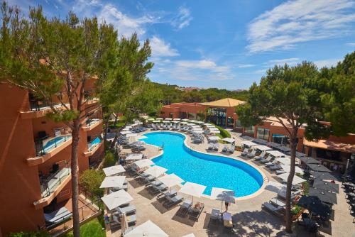an overhead view of a resort pool with lounge chairs and umbrellas at Protur Turo Pins 4* SUP in Cala Ratjada