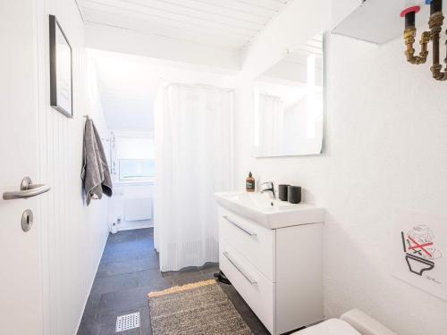 a white bathroom with a sink and a toilet at Holiday home Nørre Nebel LXXXIV in Nørre Nebel