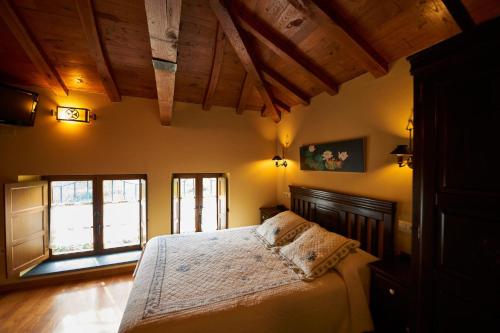 ナビアにあるApartamentos Hacienda Llamabuaの木製の天井の客室で、ベッドルーム1室(ベッド1台付)