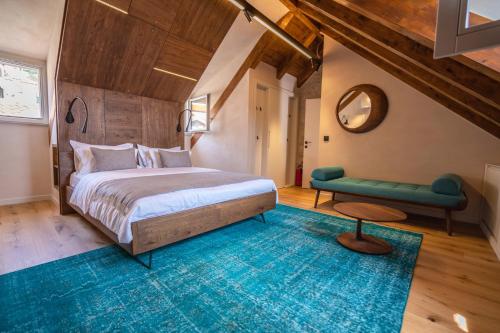 a bedroom with a large bed and a blue rug at Villa Porta Maestra in Hvar