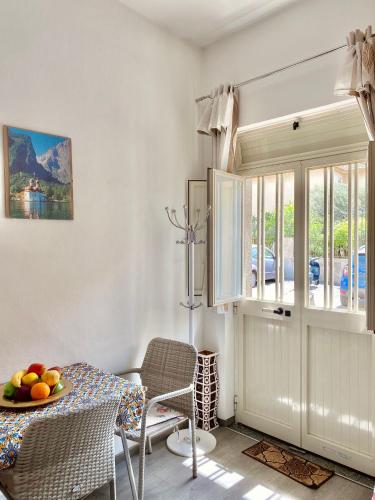 a dining room with a table with a bowl of fruit on it at Pamela House in Noto