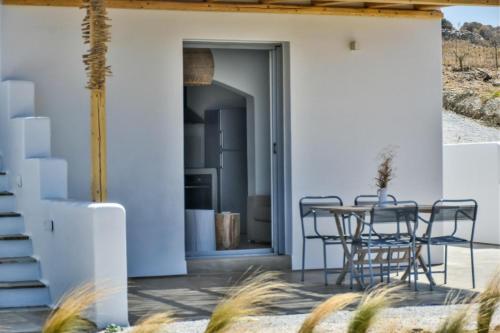 a patio with chairs and a table in a house at Relaxia Estate Naxos in Galini