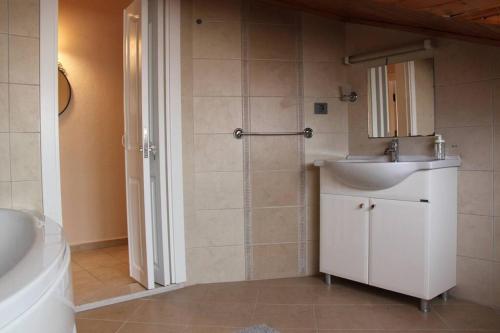 a bathroom with a sink and a toilet and a shower at Kaya Suite Sunrise in Fethiye