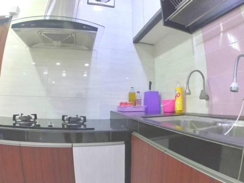 a kitchen with a sink and a counter top at Arang Homestay14pax 4room(BBQ)(Kbox)Near to Beach in Port Dickson