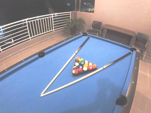 a pool table with balls on it on a balcony at Arang Homestay14pax 4room(BBQ)(Kbox)Near to Beach in Port Dickson