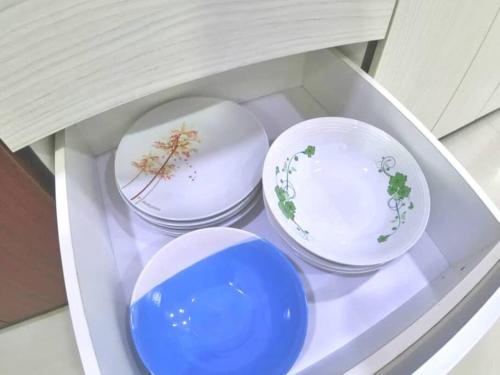 three plates sitting on a shelf in a drawer at Arang Homestay14pax 4room(BBQ)(Kbox)Near to Beach in Port Dickson