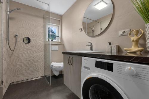 a bathroom with a washing machine and a mirror at Apartment Star in Makarska