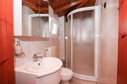 a bathroom with a shower and a sink and a toilet at Docker 2 Beachfront Villa Vourvourou by Halkidiki Villas in Vourvourou