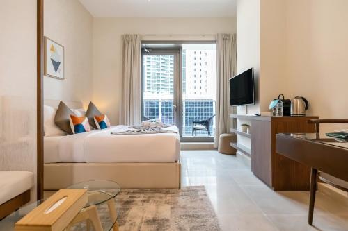 a hotel room with a bed and a window at FAM Living - Dubai Marina - Steps away from the beach in Dubai