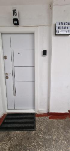 a white garage door with a sign on it at Musura Bay Apartments in Sulina