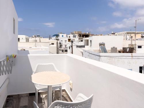 a table and chairs on the balcony of a building at George Studios in Naxos Chora