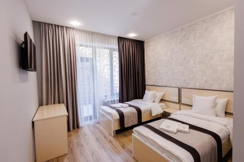 a hotel room with two beds and a window at Dream Hotel in Haghpat