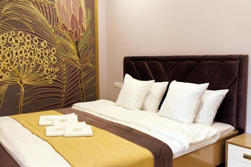 a bedroom with a bed with two towels on it at Dream Hotel in Haghpat