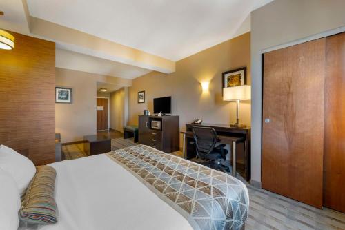 a hotel room with a bed and a desk at Best Western Plus Miami Executive Airport Hotel and Suites in Kendall
