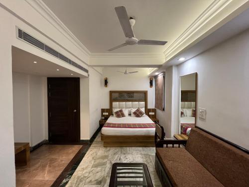 a hotel room with a bed and a couch at Hotel Moti Palace in Agra