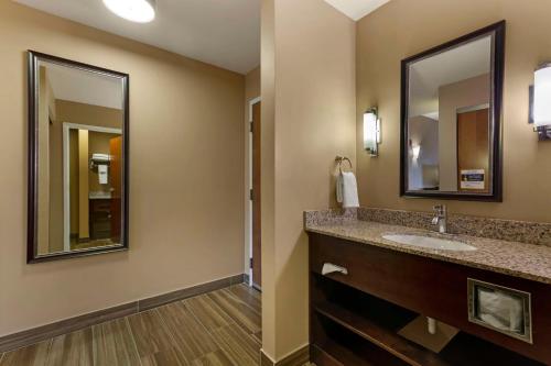 a bathroom with a sink and a mirror at Best Western Plus Miami Executive Airport Hotel and Suites in Kendall