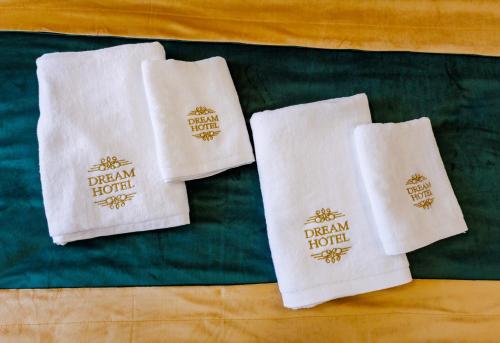 two white towels with the dream hotel on them at Dream Hotel in Haghpat