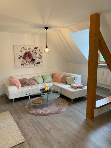 a living room with a couch and a table at Ferienwohnung 2 in Huglfing im Herzen vom 5 Seen Land Oberbayern in Huglfing