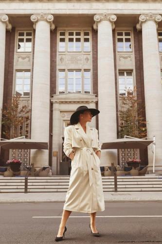 a woman walking down the street in front of a building at The Wellem, in The Unbound Collection by Hyatt in Düsseldorf