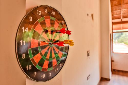 a dart board hanging on a wall at Hill Crest Resort - Coorg in Madikeri