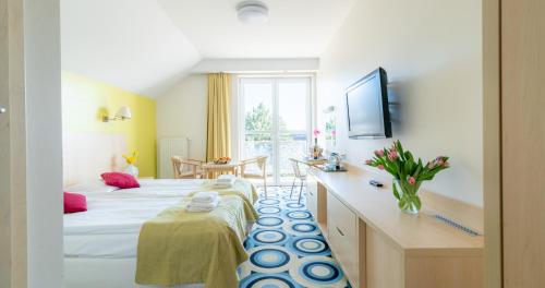 a hotel room with a bed and a desk at Ledan in Chłopy