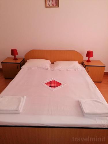 a large bed with two nightstands at Vila Albatros in Eforie Sud