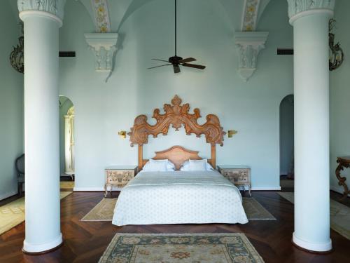 a bed in a room with columns and a ceiling at La Maison Bleue El Gouna in Hurghada