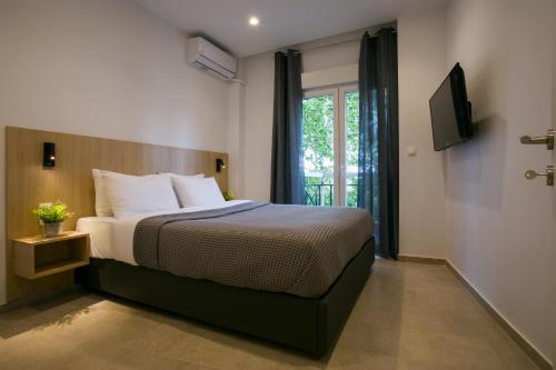 a hotel room with a bed and a window at White City Stay in Thessaloniki
