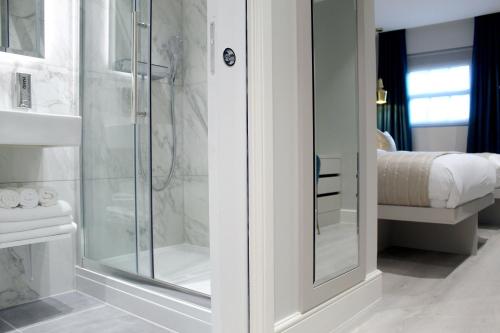 a bathroom with a shower with a glass door at NOX Richmond in Richmond